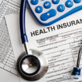 a health insurance application with a stethoscope and calculator